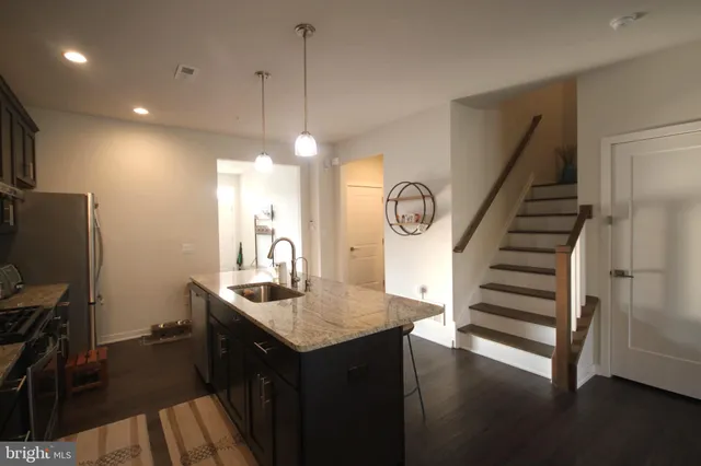 a kitchen with sink microwave and refrigerator