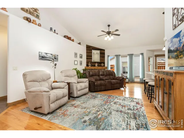 a living room with furniture a ceiling fan and a rug