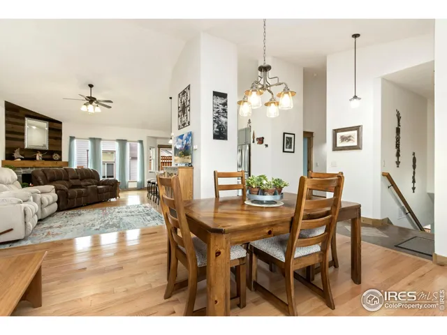 a view of a dining room with furniture and a chandelier