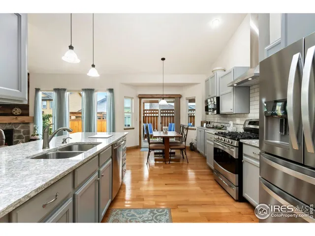a kitchen with stainless steel appliances granite countertop a stove refrigerator and cabinets