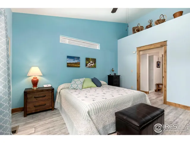 a bedroom with a bed and a lamp on table