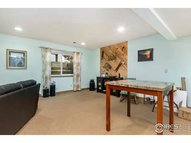 a living room with furniture a rug and a flat screen tv