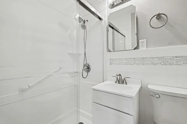 a bathroom with a sink a vanity and a shower