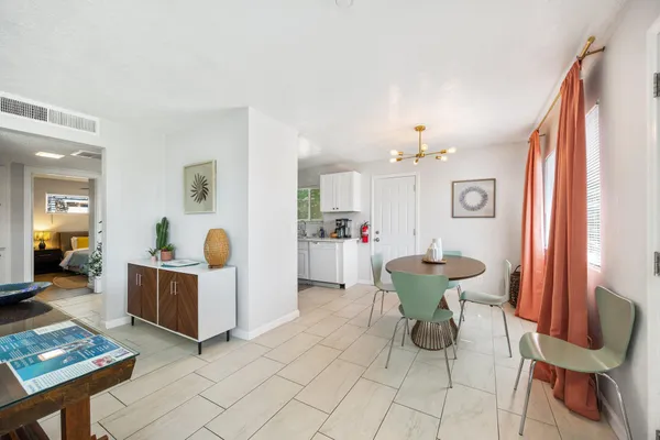 a view of a dining room with furniture and a chandelier