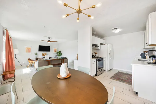 a kitchen with a table and chairs in it