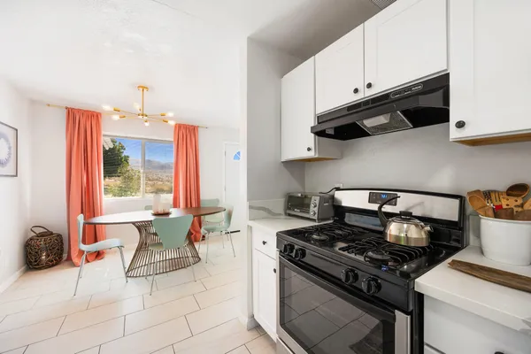 a kitchen with a stove and a refrigerator