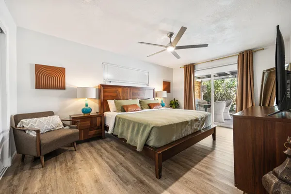 a bedroom with a bed wooden floor and window