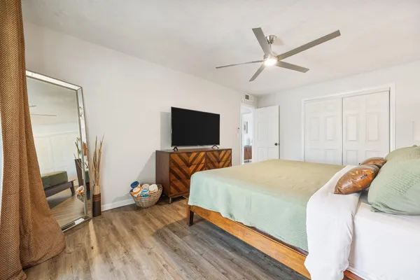 a bedroom with a bed and a flat screen tv
