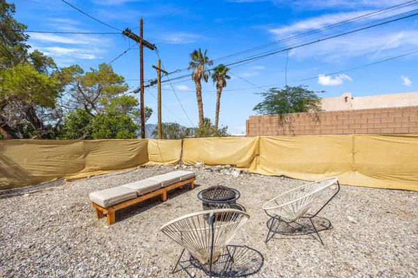 a view of a patio with a table and chairs