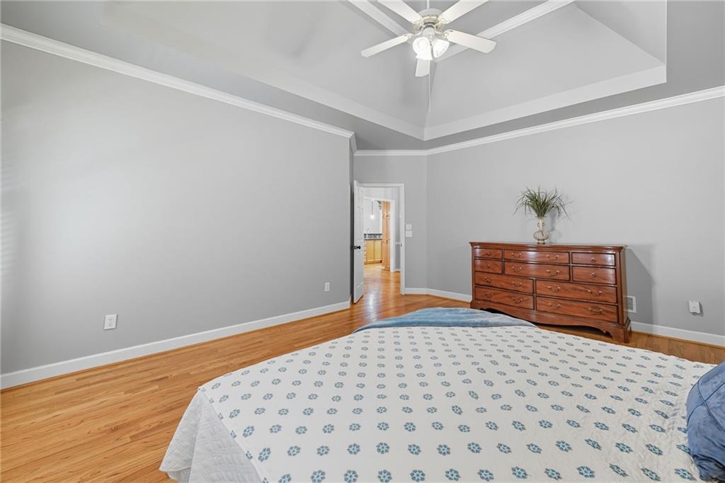 5090 Eubanks Road Woodstock, GA 30188 - Photo 17 of 54 a bedroom with a bed and a chandelier