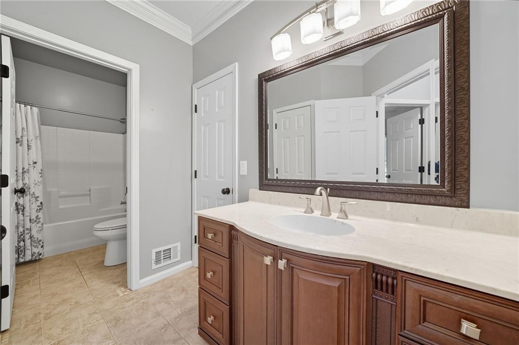 5090 Eubanks Road Woodstock, GA 30188 - Photo 18 of 54 a bathroom with a sink a toilet and a mirror