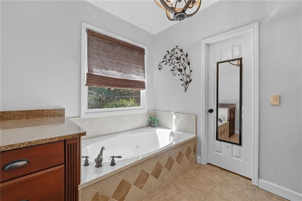 5090 Eubanks Road Woodstock, GA 30188 - Photo 20 of 54 a bathroom with a tub and a window