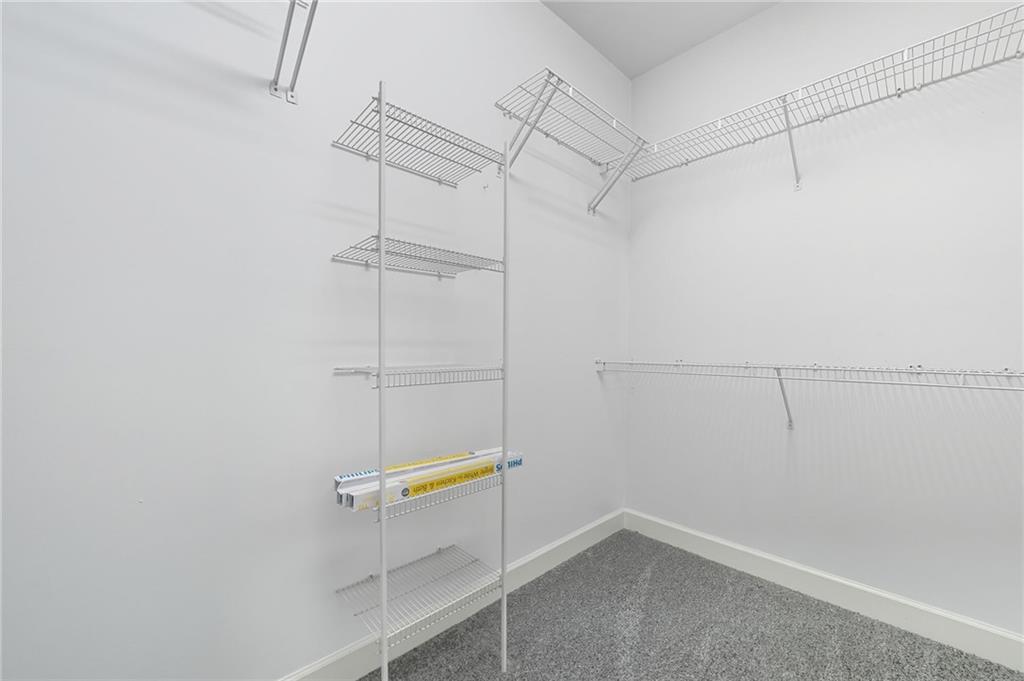 5090 Eubanks Road Woodstock, GA 30188 - Photo 22 of 54 a view of a room with racks on the wall