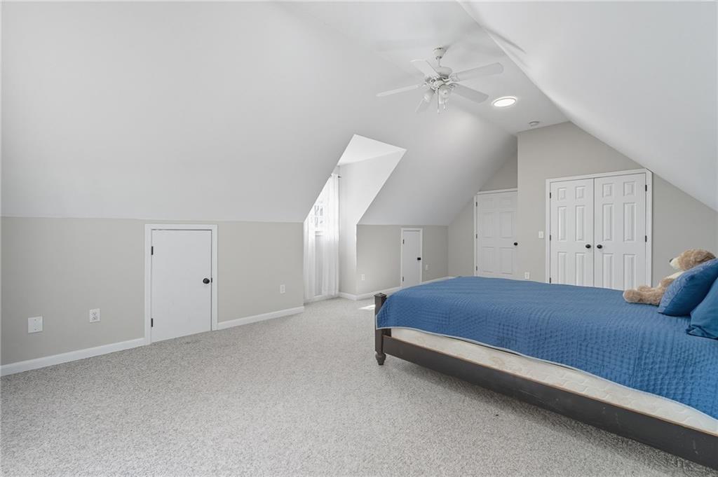 5090 Eubanks Road Woodstock, GA 30188 - Photo 24 of 54 a room with a bed and a chandelier