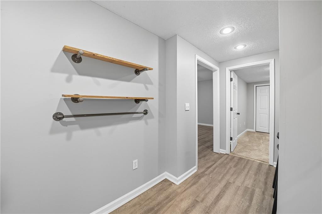 5090 Eubanks Road Woodstock, GA 30188 - Photo 40 of 54 a room with wooden floor and white walls