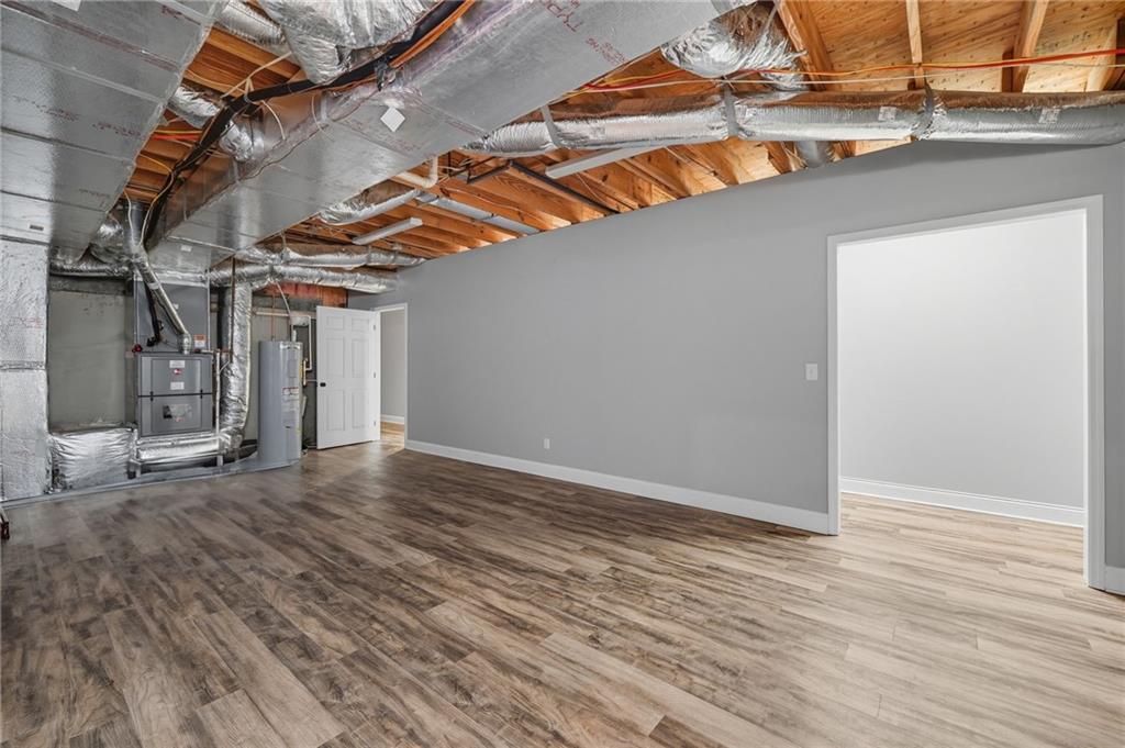 5090 Eubanks Road Woodstock, GA 30188 - Photo 46 of 54 an empty room with wooden floor and windows