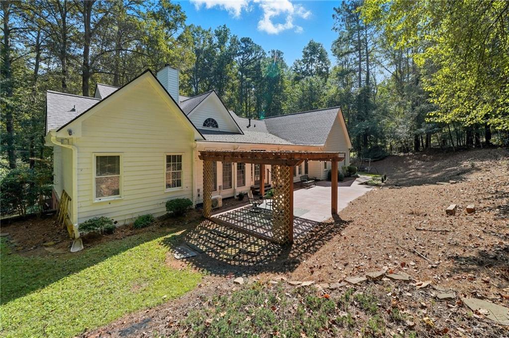 5090 Eubanks Road Woodstock, GA 30188 - Photo 50 of 54 a view of a house with a yard