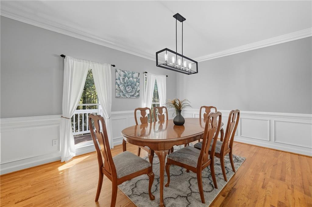 5090 Eubanks Road Woodstock, GA 30188 - Photo 7 of 54 a view of a dining room with furniture wooden floor and chandelier