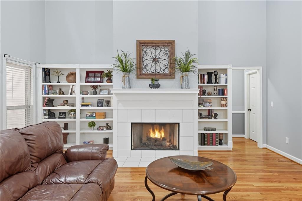 5090 Eubanks Road Woodstock, GA 30188 - Photo 9 of 54 a living room with furniture and a fireplace
