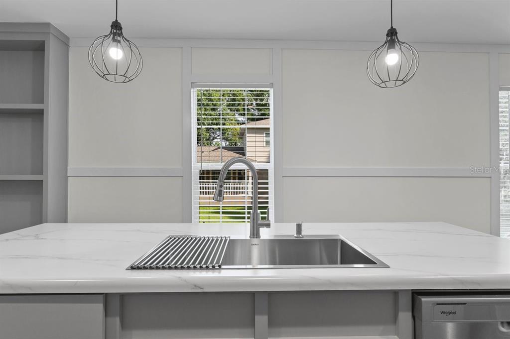 811 North Swindell Avenue, Unit 2 Lakeland, FL 33815 - Photo 18 of 33 a kitchen with a sink and a chandelier