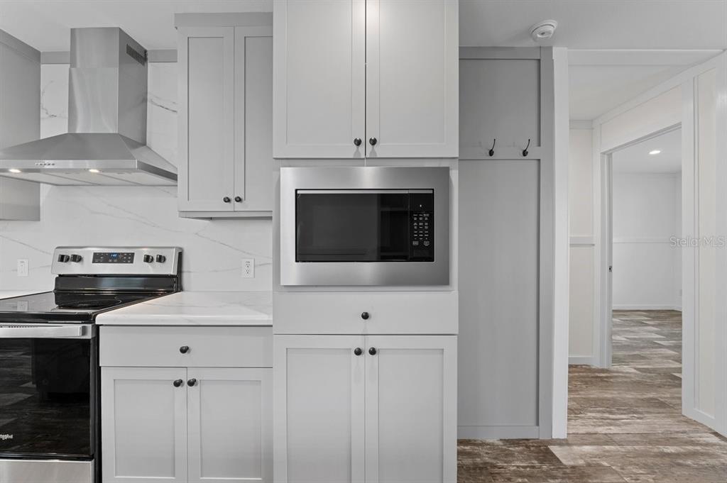 811 North Swindell Avenue, Unit 2 Lakeland, FL 33815 - Photo 21 of 33 a kitchen with stainless steel appliances white cabinets and white appliances