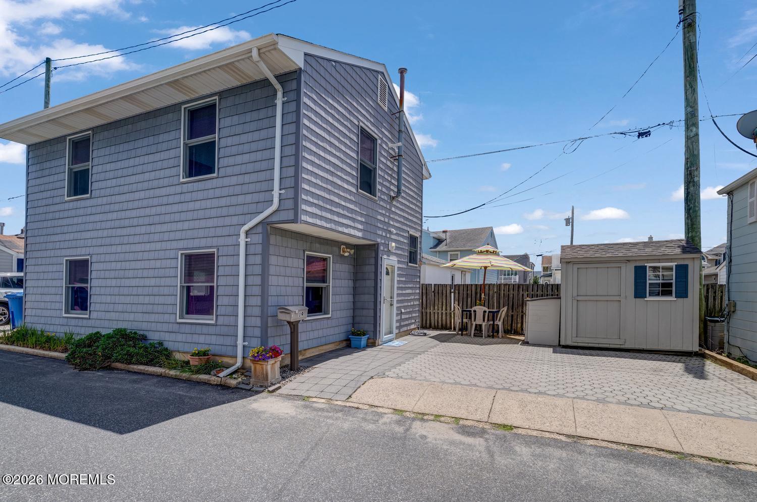 19 Shore Way Lavallette, NJ 08735 - Photo 2 of 38 a front view of a house with a yard and garage