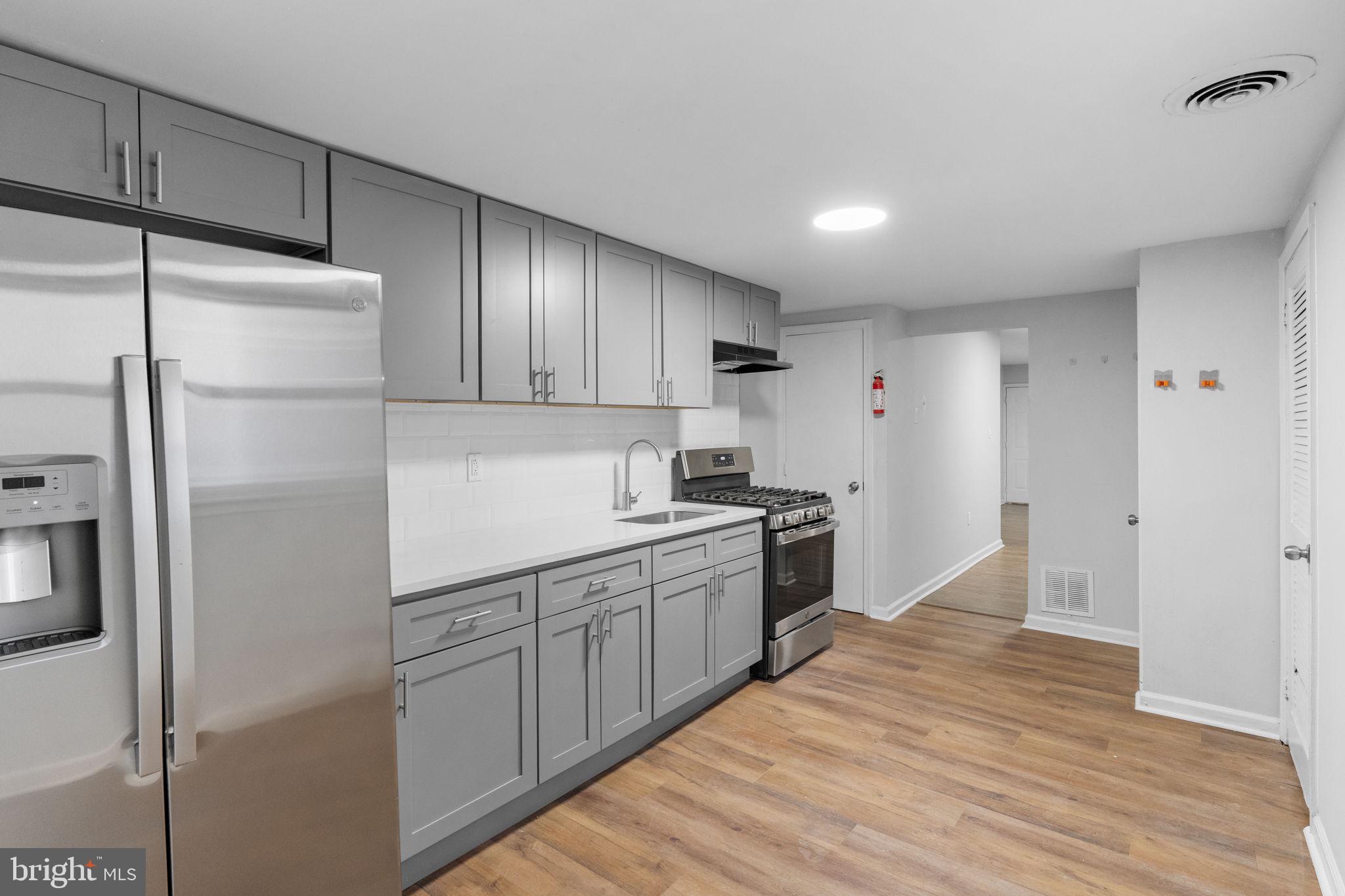 1020 Potter Street Chester, PA 19013 - Photo 11 of 26 a kitchen with a sink and refrigerator