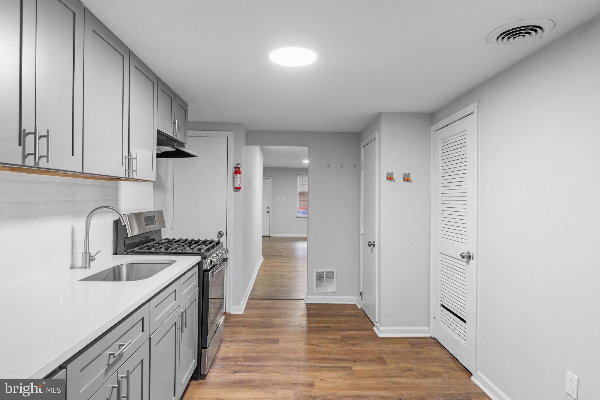 1020 Potter Street Chester, PA 19013 - Photo 12 of 26 a kitchen with a sink stove and cabinets