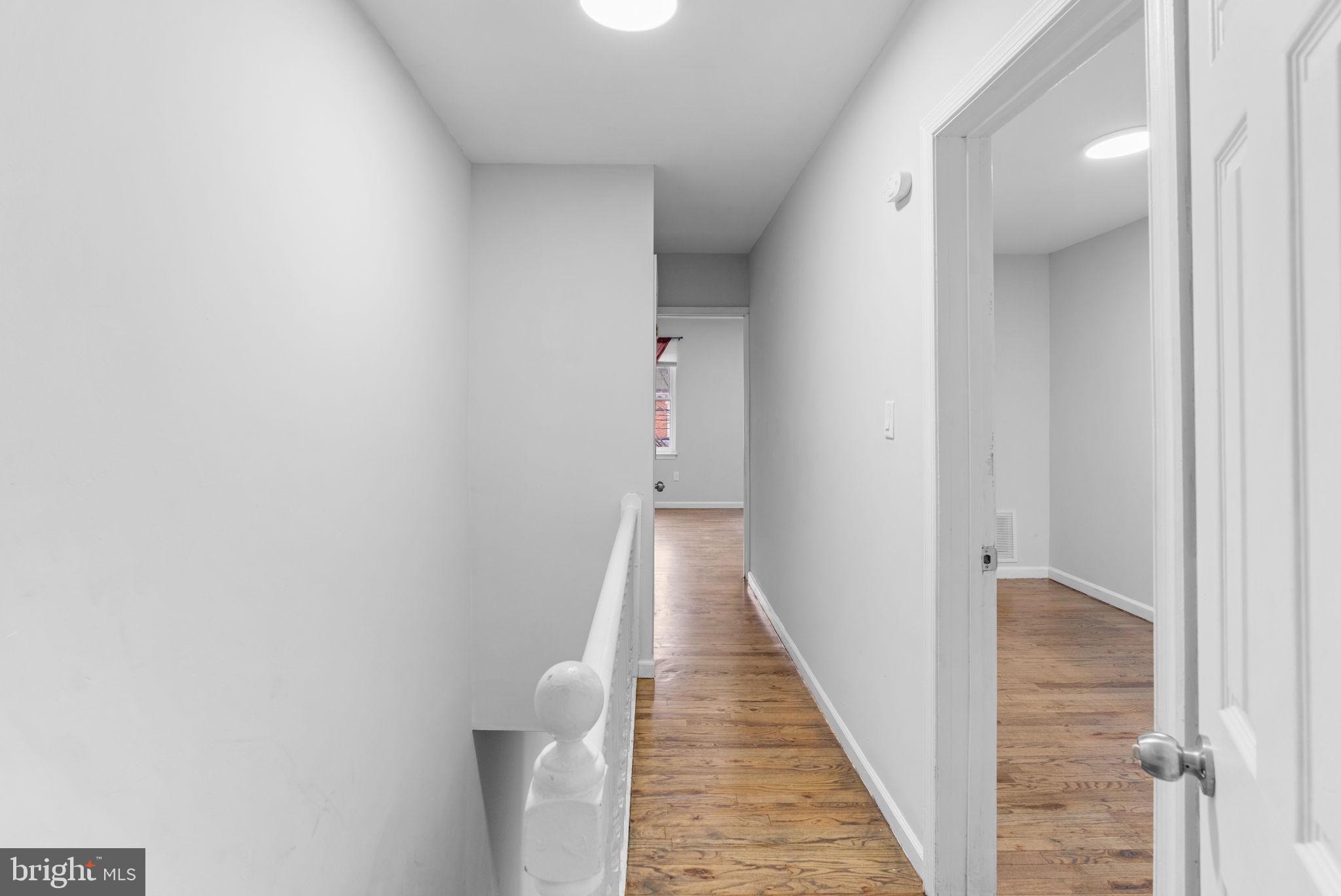 1020 Potter Street Chester, PA 19013 - Photo 13 of 26 a view of a hallway with wooden floor and staircase