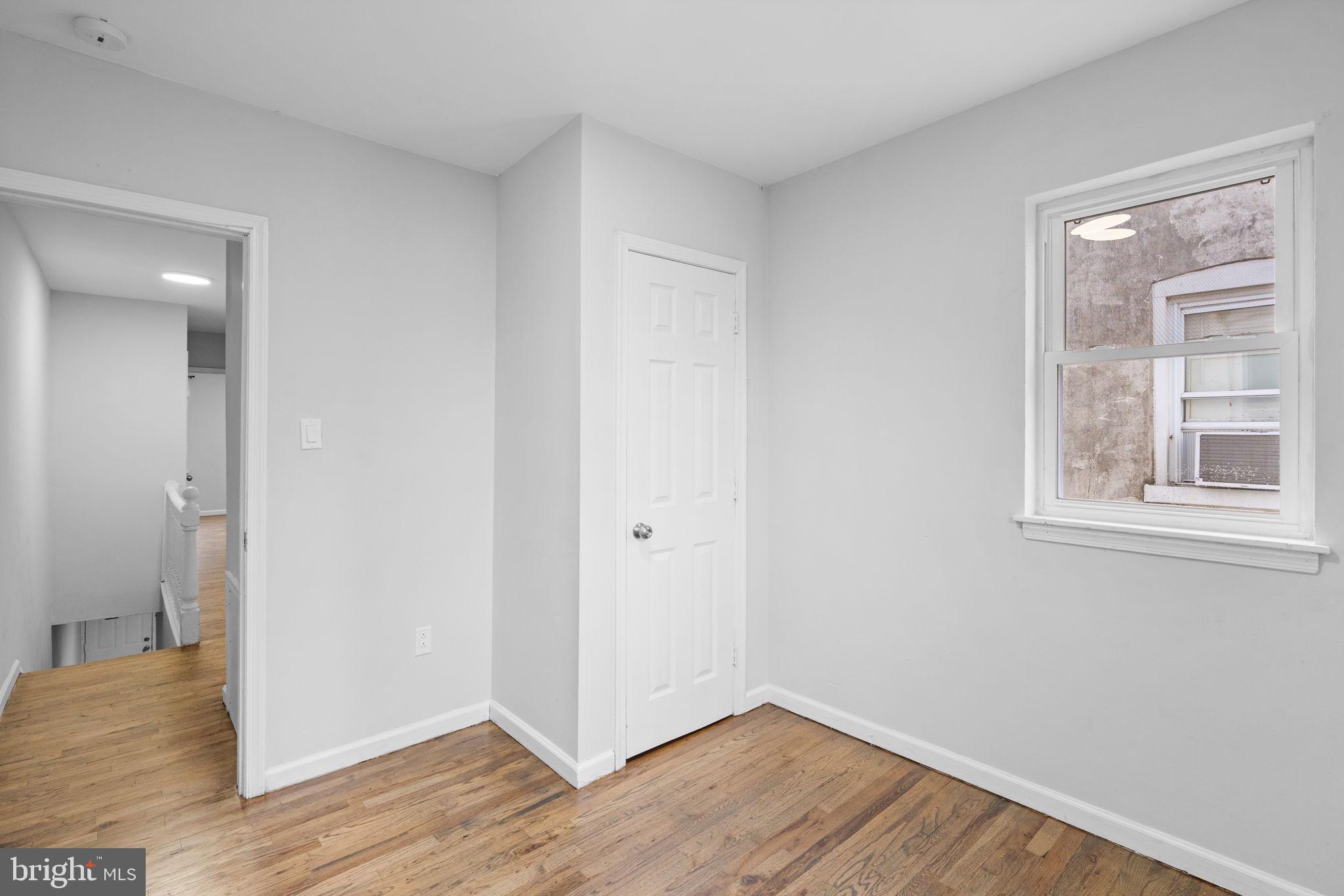 1020 Potter Street Chester, PA 19013 - Photo 18 of 26 a view of an empty room with wooden floor and a window
