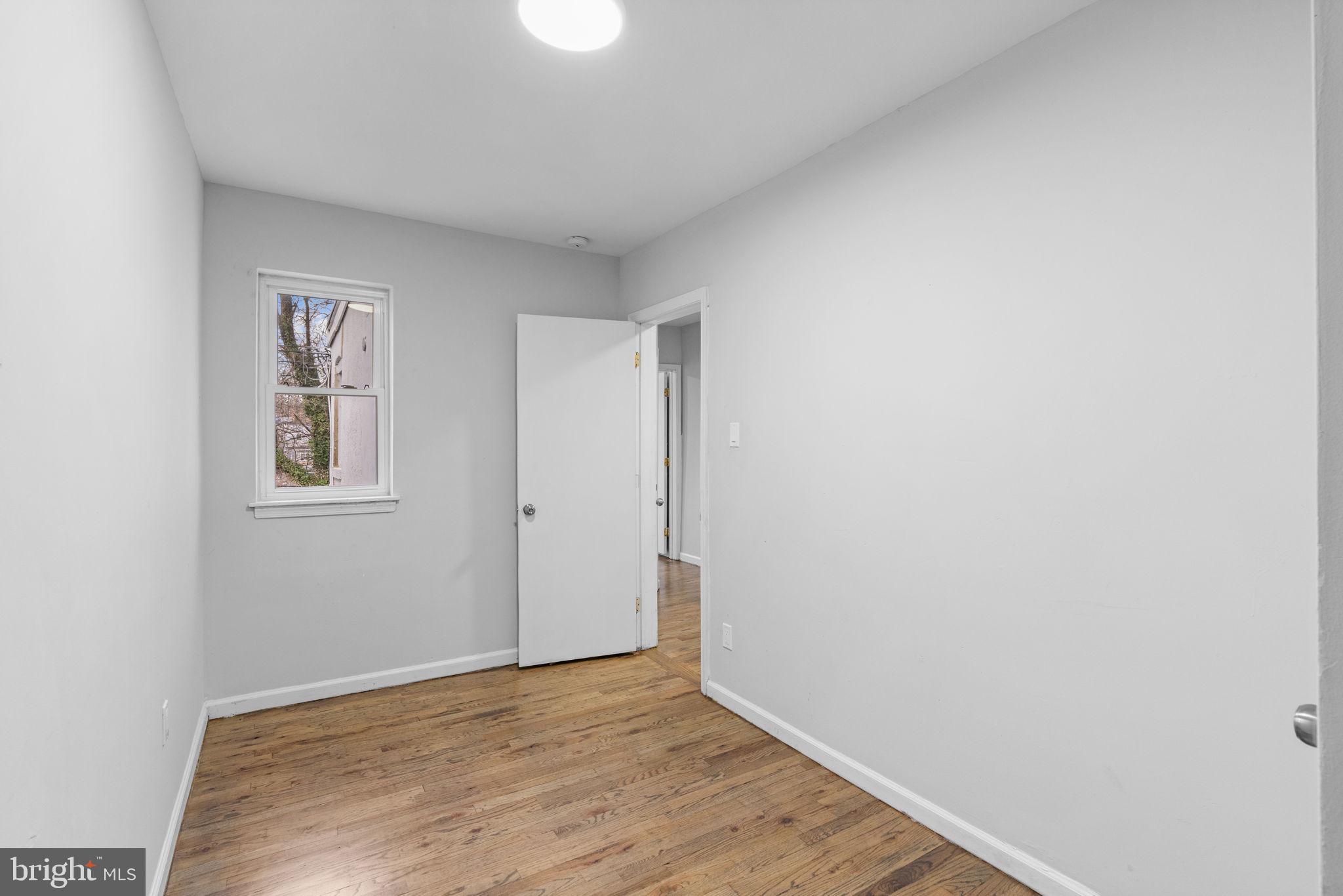 1020 Potter Street Chester, PA 19013 - Photo 21 of 26 a view of an empty room with wooden floor and a window