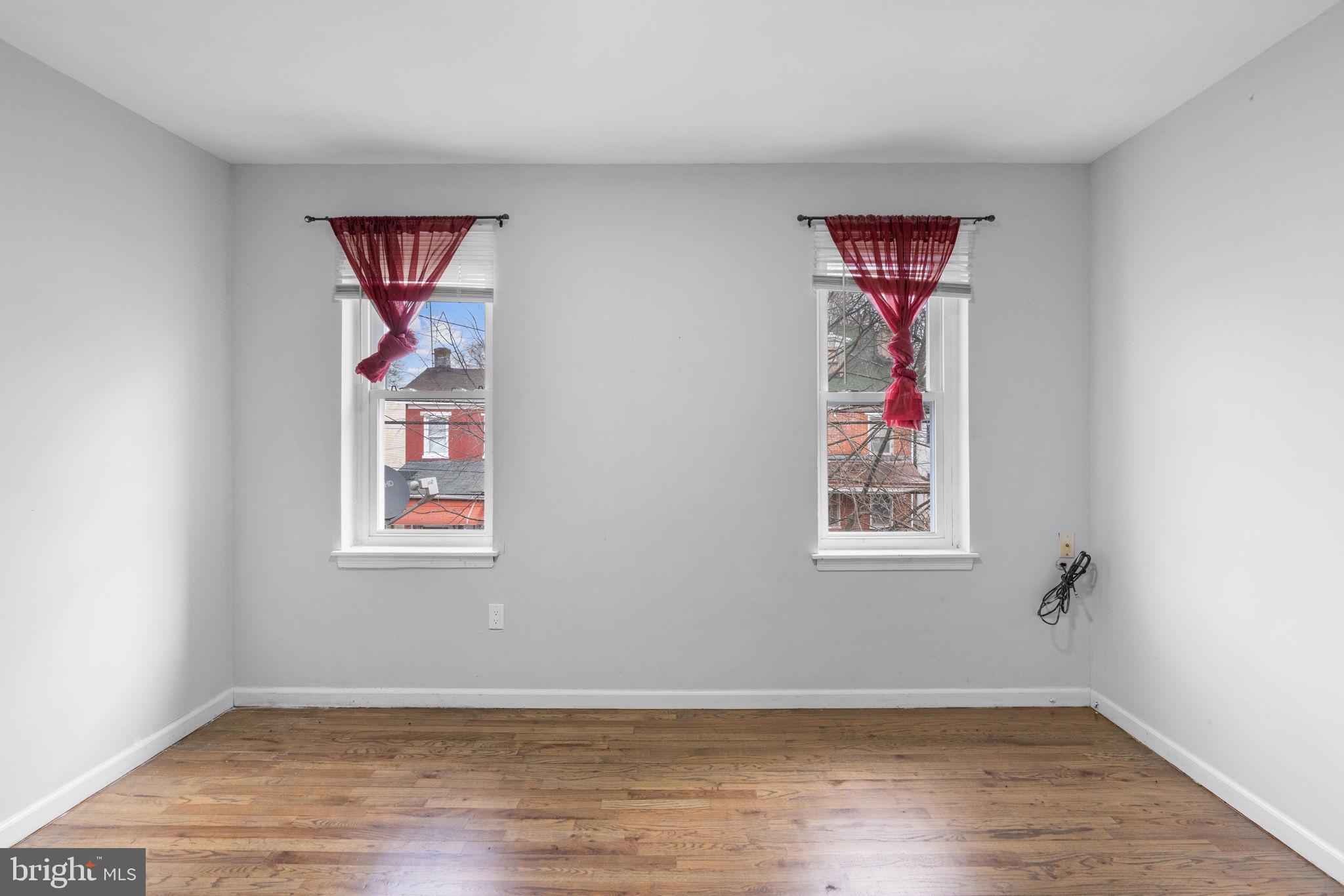 1020 Potter Street Chester, PA 19013 - Photo 23 of 26 a view of an empty room with wooden floor and a window