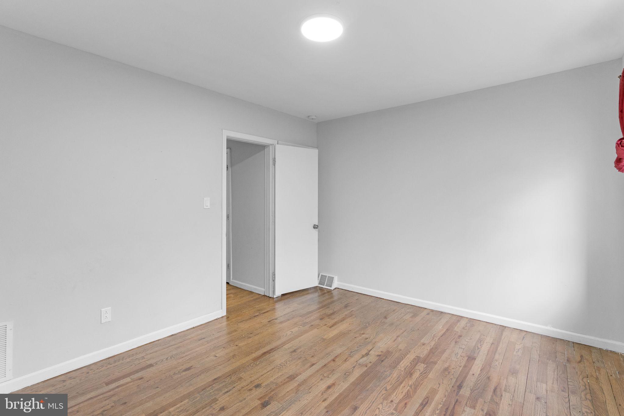 1020 Potter Street Chester, PA 19013 - Photo 25 of 26 a view of an empty room with wooden floor and white doors
