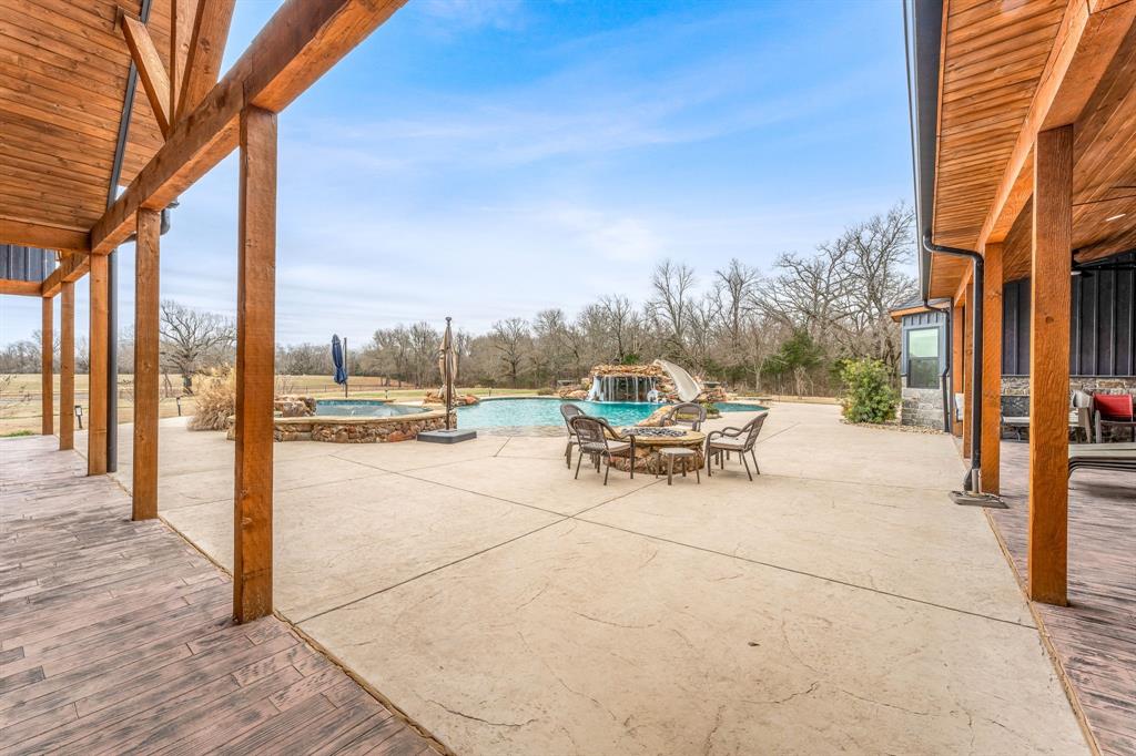 239 32507th Road Paris, TX 75460 - Photo 30 of 40 View of patio / terrace with an outdoor fire pit and a pool with connected hot tub
