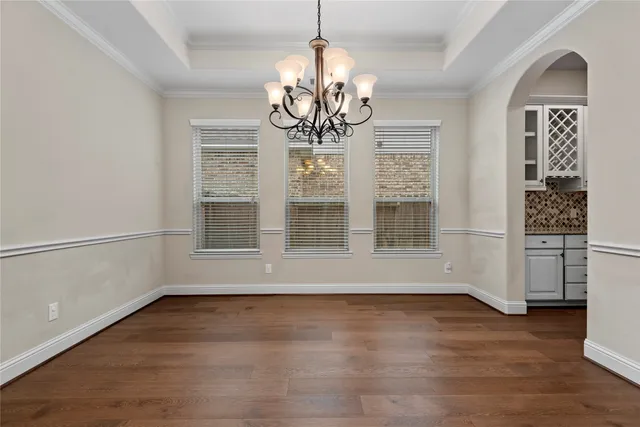 a kitchen with granite countertop white cabinets and stainless steel appliances