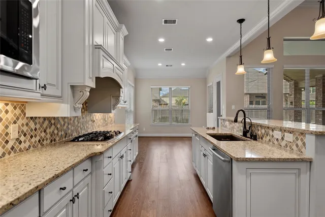 a view of an empty room with wooden floor fireplace and a window