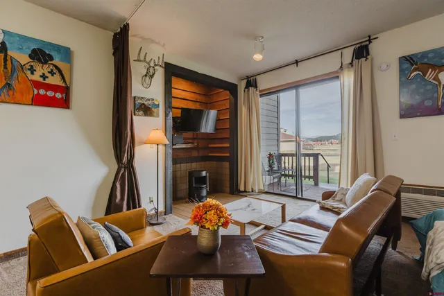 a living room with furniture fireplace and a flat screen tv