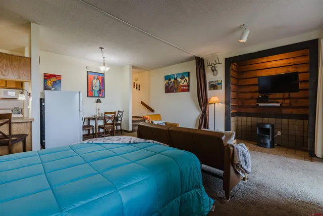 a bedroom with a bed and a television