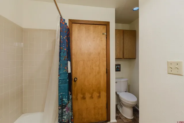 a bathroom with a toilet and shower