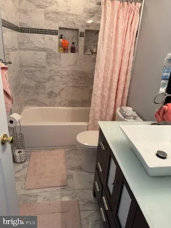a bathroom with a sink a toilet and a bathtub