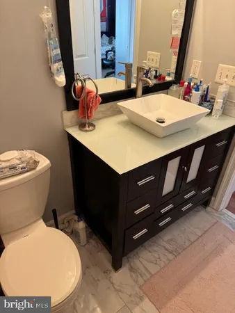 a bathroom with a sink a toilet and mirror
