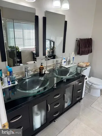 a kitchen with a sink and a mirror