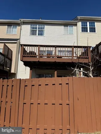 a view of a balcony with furniture and wooden floor