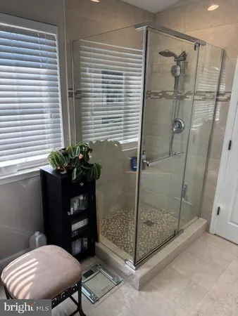 a bathroom with a shower a toilet and a sink