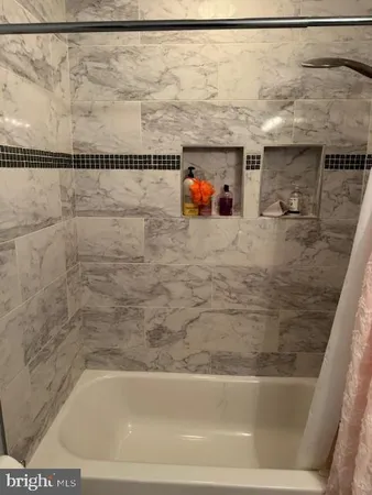 a bathroom with a shower and a bath tub