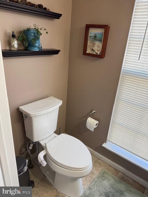6357 Regal Oak Drive Springfield, VA 22152 - Photo 30 of 42 a white toilet sitting next to a bathroom sink and vanity