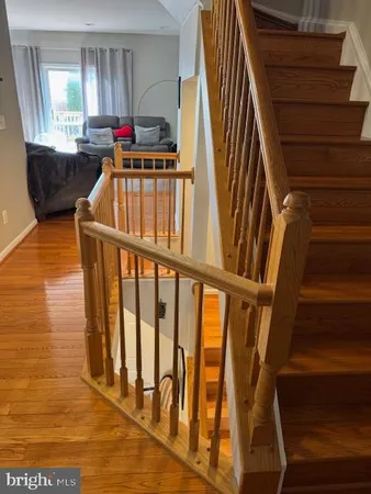 a view of staircase with white walls and railing