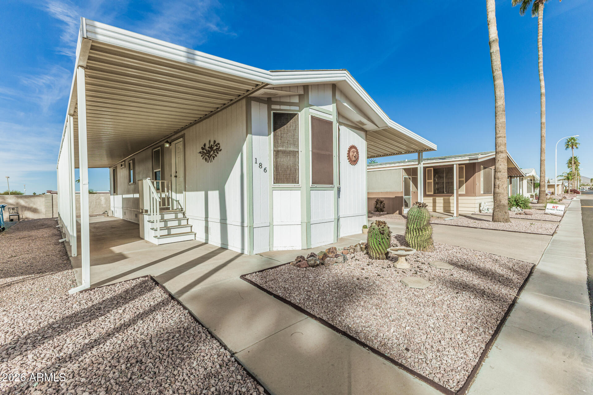 9302 East Broadway Road, Unit 186 Mesa, AZ 85208 - Photo 11 of 40 a front view of a house with a yard
