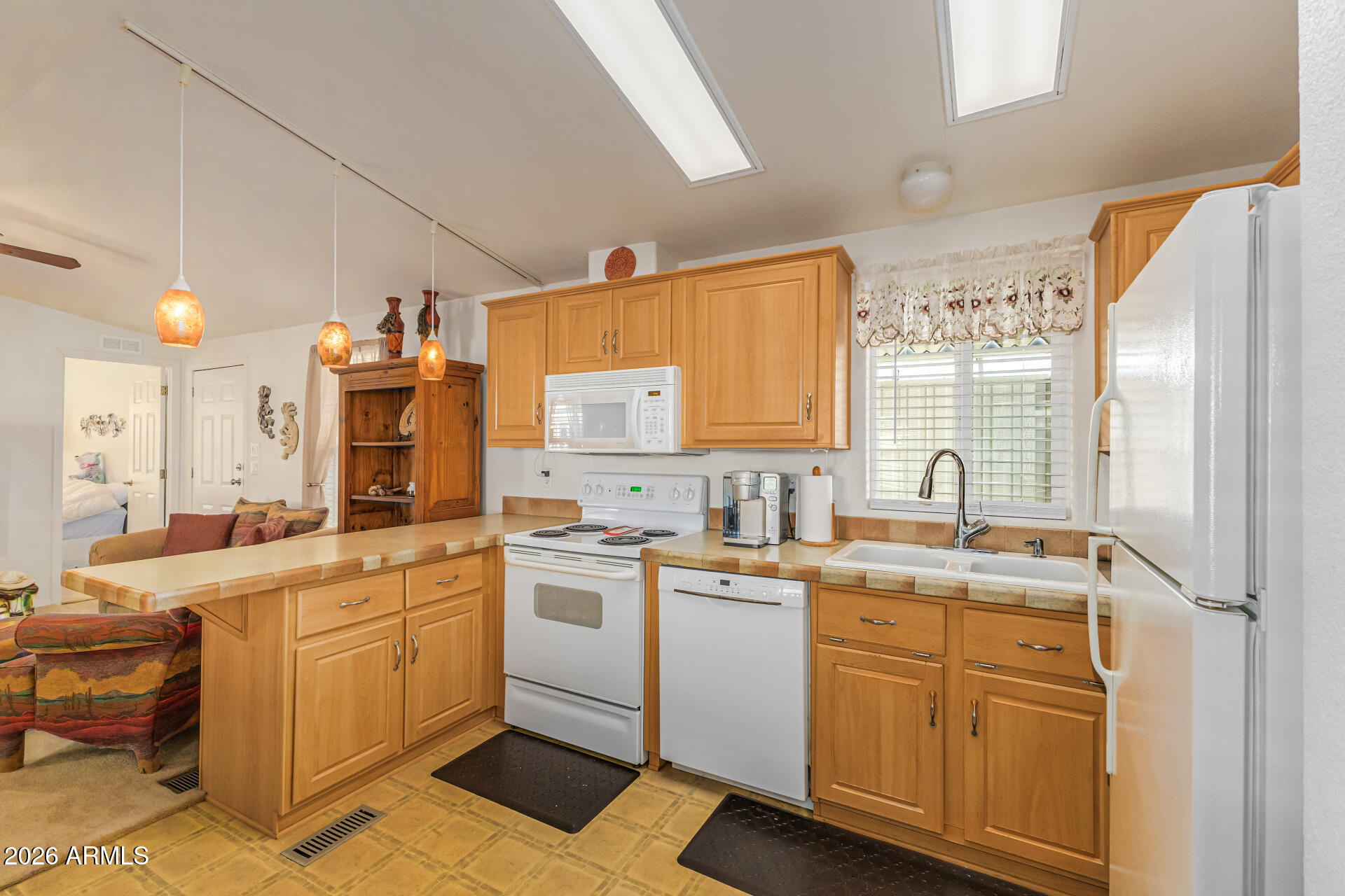 9302 East Broadway Road, Unit 186 Mesa, AZ 85208 - Photo 18 of 40 a kitchen with a sink stove and cabinets