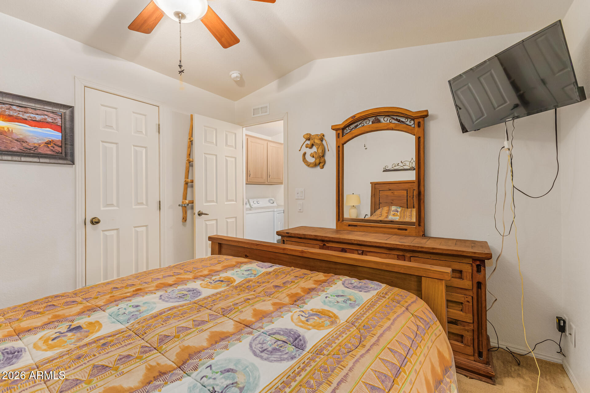 9302 East Broadway Road, Unit 186 Mesa, AZ 85208 - Photo 20 of 40 a bedroom with a bed and a chandelier